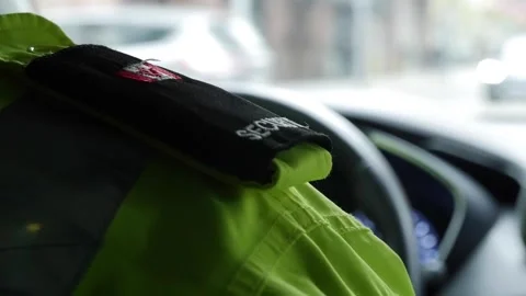 Shallow focus of the patch on the shoulder of security personnel driving a car Stock Footage 154543531
