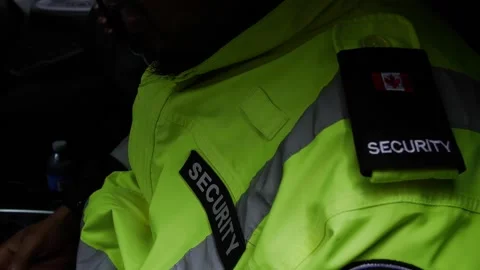Shallow focus of the patch on the shoulder of security personnel driving a car Stock Footage 154543560