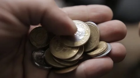 Shallow focus shot from a man counting Brazilian Real coins in his hands Video stock 209713248