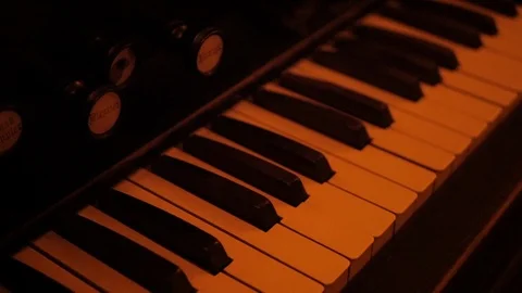 Shallow Focus Slide over Keys of Antique Beckman Organ Company Piano Video stock 122230245