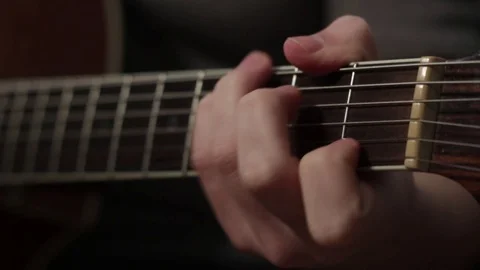 Shallow focus of the technique of the play on acoustic guitar Stock Footage 70717364