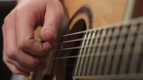 Shallow focus of the technique of the play on acoustic guitar Stock Footage 70719182