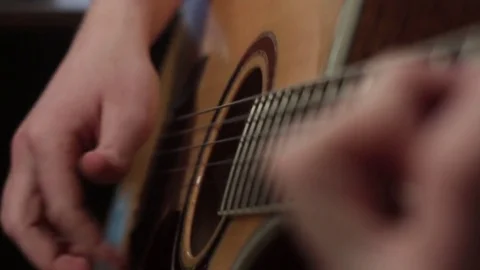 Shallow focus of the technique of the play on acoustic guitar Stock-Footage 70720925