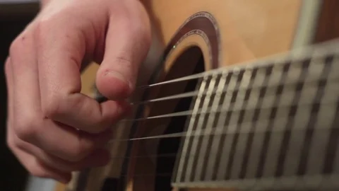 Shallow focus of the technique of the play on acoustic guitar Stock-Footage 70852225