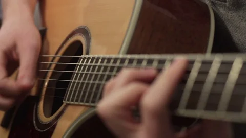 Shallow focus of the technique of the play on acoustic guitar Video stock 70852331