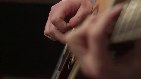 Shallow focus of the technique of the play on acoustic guitar Stock Footage 70852992