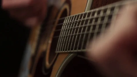Shallow focus of the technique of the play on acoustic guitar Stock Footage 70853519