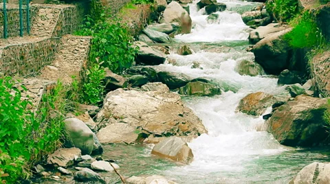 Shallow mountain river with artificial cascades made of rocks Stock Footage 65730115