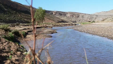 Shallow Mountain Stream Through Rocky Valley in Morocco's Eastern High Atlas 動画素材 348969889