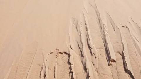 Shallow ravines formed in the side of dune Stock Footage 76936283