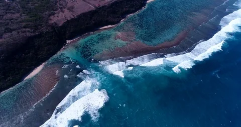 Shallow reef with deeper part, waves crashing and cliffs on coast Stock Footage 114605071