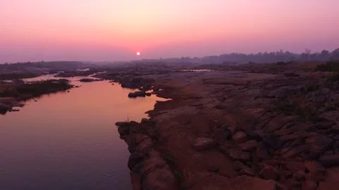 Shallow River and Rocky Landscape at Red Sunset – Aerial View Stock Footage 314697215