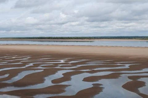 Shallow river with a large sandy beach Stock Photos