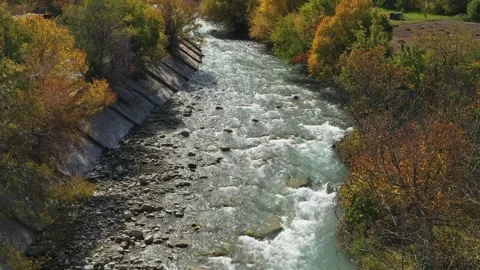 Shallow river meanders through a vibrant autumn landscape Stock-Footage 288111815