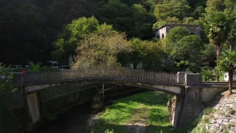 Shallow river Psyrtskha and beautiful little bridge, Abkhazia Stock Footage 152765060