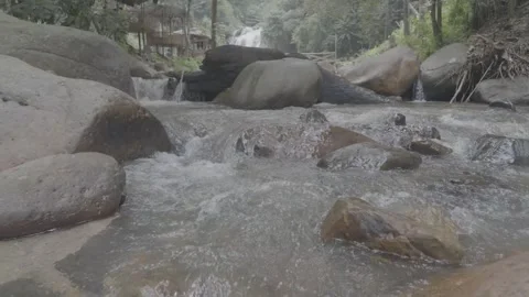 Shallow River Water Flowing with Waterfall in Distance Stock Footage 345471268