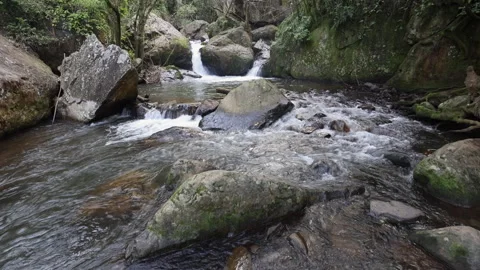 Shallow Sabie River drops elevation in riffles through stone boulders Stockbeeldmateriaal 297248371