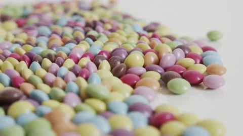 Shallow sliding on button shaped bonbons 4K video Video stock 153879689