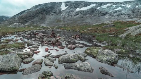 A shallow stream with a rocky bottom in the mountainous plateau. Stock Footage 270349479