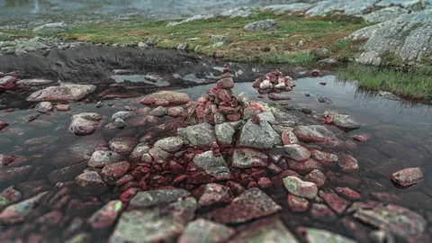 A shallow stream runs through the rocky terrain of a mountainous plateau. Stock Footage 270036566