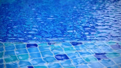 Shallow wadding pool water in swimming pool. pool design with small ceramic t Stock Photos