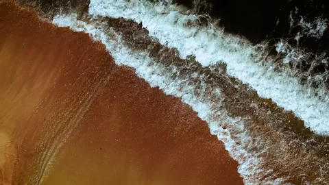 Shallow wave touching golden sandy beach. Sea foam sparkling on smooth wet shore Stock Footage 319757636
