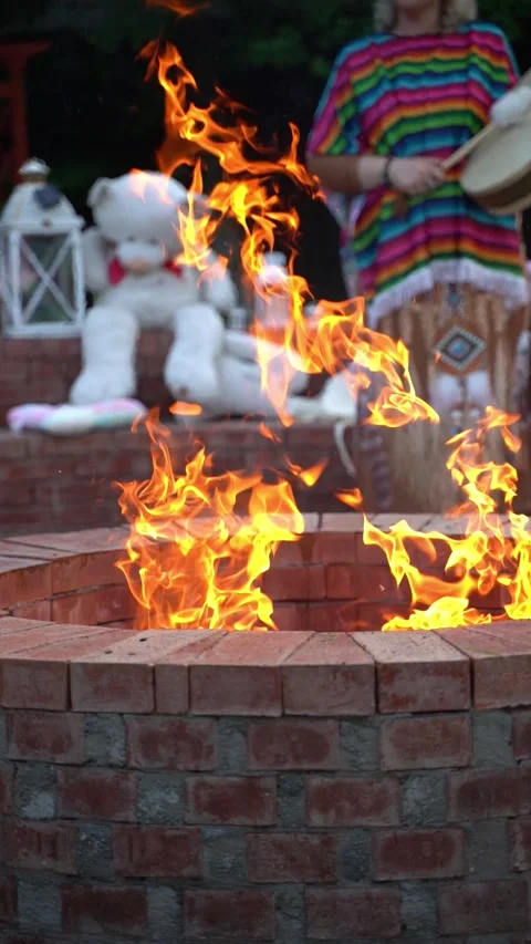 Shaman behind a fire with teddy bear in background Stock Footage 314056121