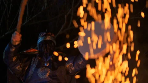 The shaman hits the drum sitting by the fire. Video stock 106789147