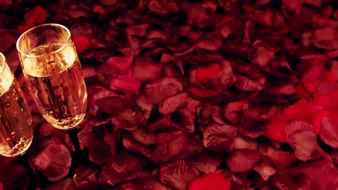 Сhampagne glasses on celebration table.Table covered with petals red roses. Stock Footage 85582951