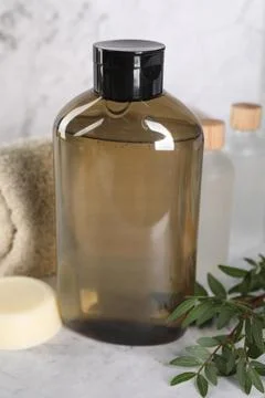 Shampoo bottle, essential oils, folded towel and solid shampoo bar on white.. 写真素材