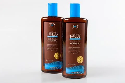 Shampoo bottles on white background showcasing therapeutic hair care solution Stock Photos