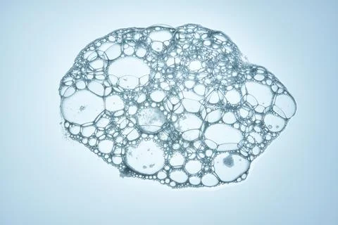 Shampoo bubbles on a blue background. Stock Photos