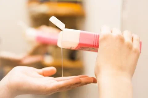 Shampoo flowing in the hand, close up Stock Photos
