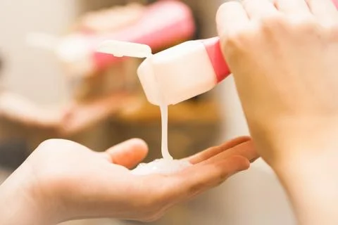 Shampoo flowing in the hand, close up Stock Photos