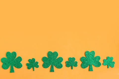 Shamrocks pattern on bright orange background. Minimal concept. Copy space fo Stockfoto's