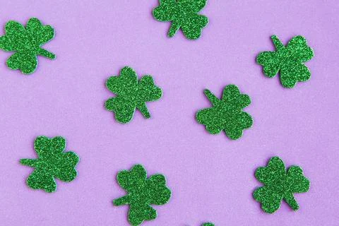 Shamrocks pattern on purple background. Minimal concept. Copy space for the t Stock Photos