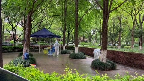 Shanghai Covid lockdown nucleic acid testing in the rain in resident compound 12 Stock Footage 185850834