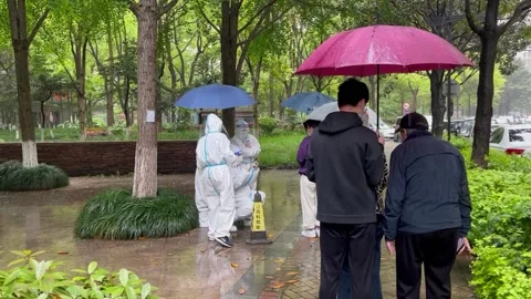 Shanghai Covid lockdown nucleic acid testing in the rain in resident compound 10 Stock Footage 185850844