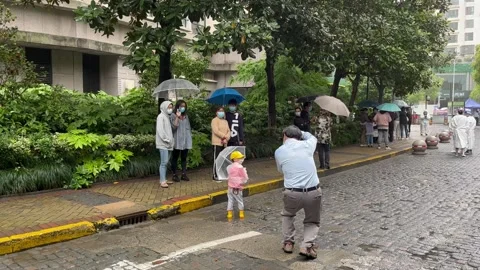 Shanghai Covid lockdown nucleic acid testing in the rain in resident compound 4 Stock Footage 185851137