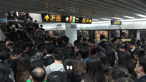 MAN WITH MEGAPHONE PUSH COMMUTERS INTO CROWDED TRAIN SO DOORS WILL CLOSE  RUSH HOUR AT PEOPLE S SQUARE SHANGHAI CHINA Stock Photo - Alamy