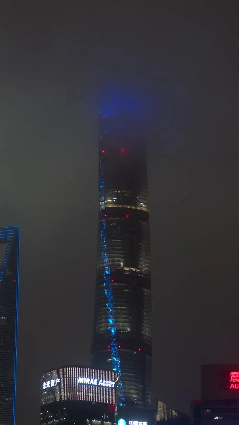 SHANGHAI Tower illuminated through night fog in Pudong SHANGHAI CHINA 库存影片 344942615