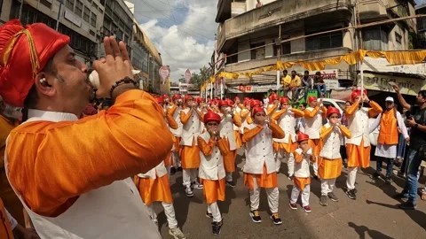 Shankhnaad, performs with hundreds of conch blowers. during Ganesh visarjan Stock Footage 285334912