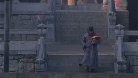Shaolin monk walking down the stairs Stock Footage 89761723