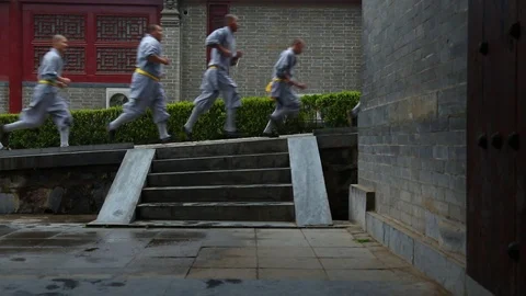 Shaolin monks running on the slope while Kung fu training Stock Footage 88677175