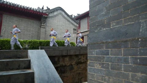 Shaolin monks running on the slope while Kung fu training Stock Footage 88677351