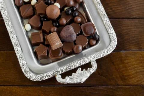 Shape classy chocolates in vintage, silver metal tray Stock Photos