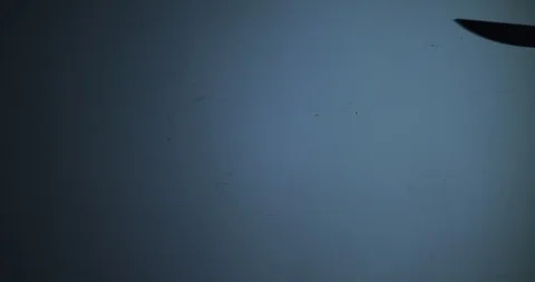 The shape of a hand with a knife on blue background ready to kill someone 스톡 동영상 123504403