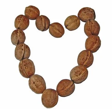 The shape of a heart made of several walnuts Fotos Stock