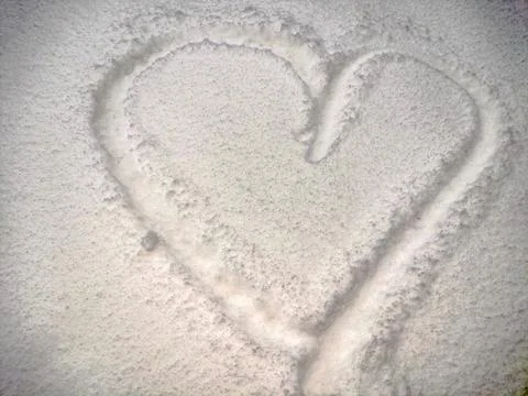 The shape of a heart made of snow Фото