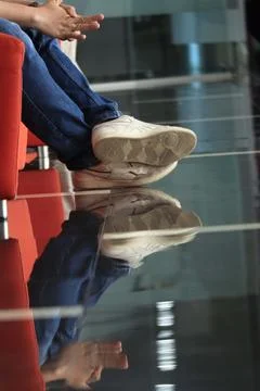 Shape of leg's reflection on the floor Stock Photos